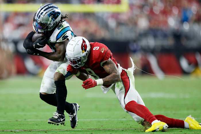 running back Ameer Abdullah runs with the ball in his hands as Arizona Cardinals linebacker Isaiah Simmons leans to tackle him
